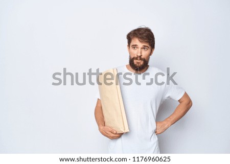  paper bag in the hands of a bearded man                              