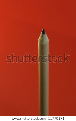 a pencil  with a simple  red color background