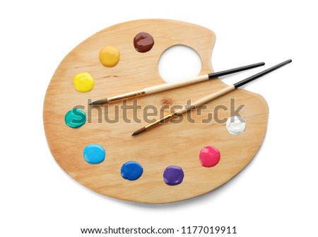 Palette with paints and brushes on white background, top view Royalty-Free Stock Photo #1177019911