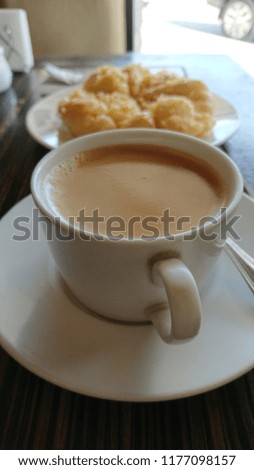 Coffee with bread on table