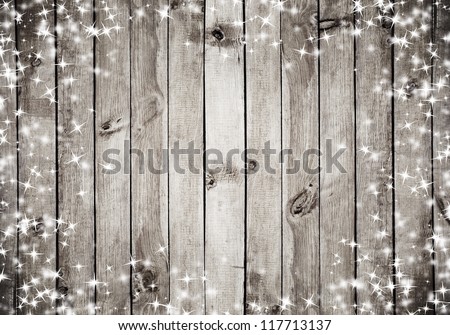 the brown wood texture with white snow and stars. Christmas background