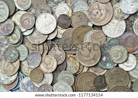 Soviet coins sprinkled on the whole frame of the photo. The USSR ruble. Old coins for numismatics.