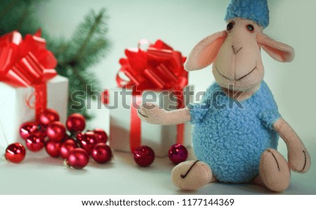 blue toy sheep and boxes with gifts for Christmas