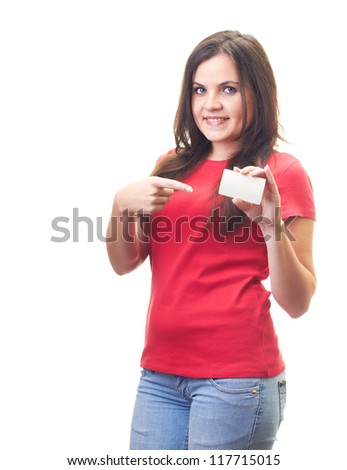 Attractive smiling young woman in a red shirt holds a poster in the left hand and the right hand points to the poster. Isolated on white background