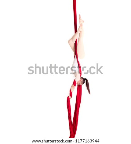 Woman hanging in aerial silks, isolated on white. Beautiful geometric poses.