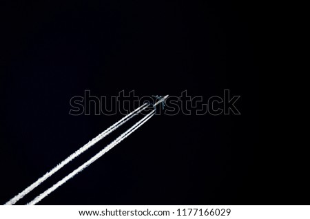 Airplane flying in between forests