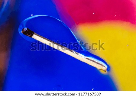 match in a colorful background of water and oil drops