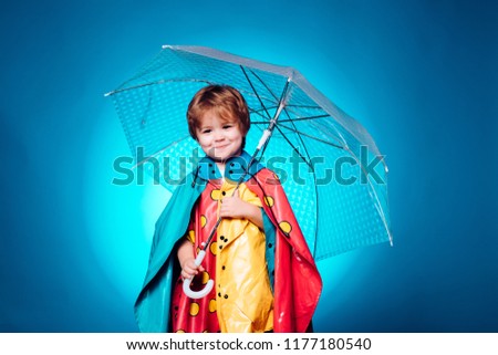 Child with color umbrella on blue sky. Autumn copy spaceAutumn trend and autumn vogue. Ready for text. Autumn Dress. Autumn time for Fashion sale. Happy kids playing. Rain and umbrella november Royalty-Free Stock Photo #1177180540