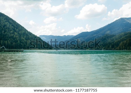 Fantastic views of the tranquil lake with amazing reflection. Mountains & glacier in the background. Peaceful & picturesque landscape. Location: Austria, Europe. Artistic picture. Beauty world. Rain