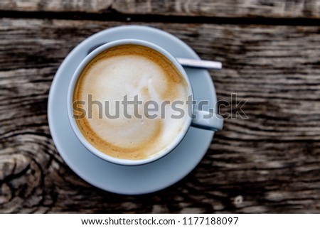 Top view a cup of cappuccino, White coffee cup on wooden table with selective focus.