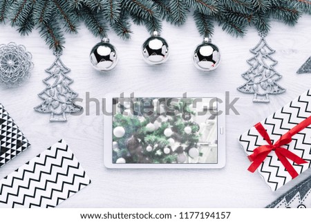Beautiful celebratory Christmas background. New Year's holidays. Christmas holidays. Beautiful Christmas decorations on the wooden background. Digital technology. Tablet copy space text 