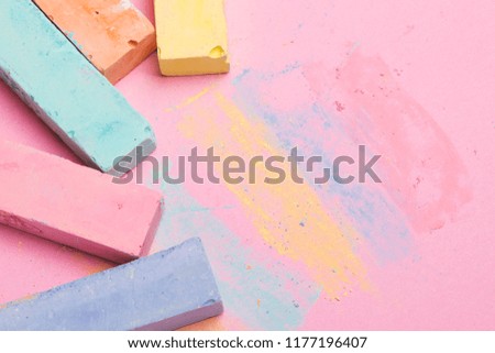 Multicolored crayons on a yellow and purple background with free space. Education, children's game, art  concept.  