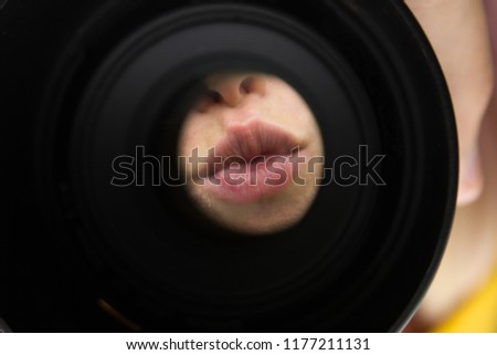 soft focus female partly face portrait lips in creative foreshortening through camera lens with circle shape black frame and empty copy space for your text