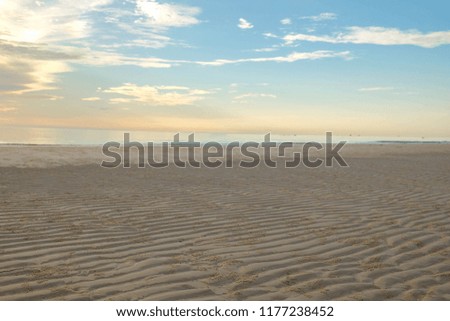 vintage tourism concept picture of summer sunset over sand beach with reflection in Thailand