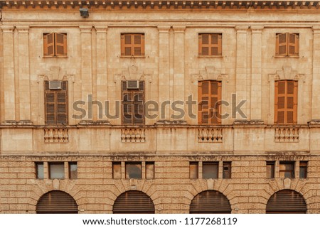 Coral pink peeled antique vintage facade wall with balconies. Classic European architecture. Postcard concept. Travel inspiration. Luxury estate background. Film effect.