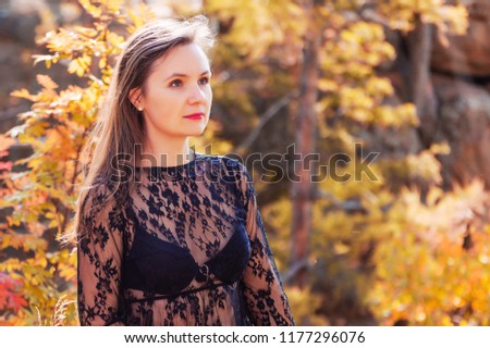Beautiful woman in autumn forest, toned