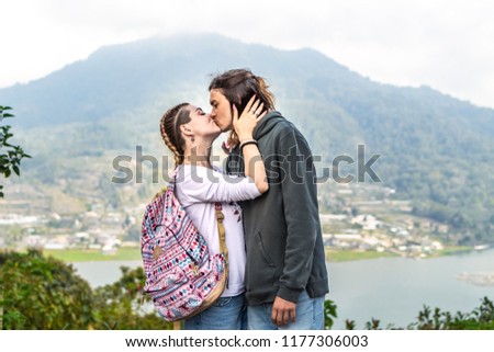 Portrait of beautiful young couple enjoying nature on a mountain background.