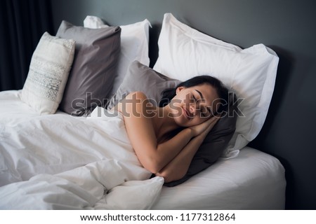 Good dreams make your day better. Attractive young woman sleeping joyfully Royalty-Free Stock Photo #1177312864