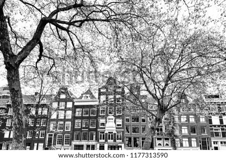 Historic buildings in the city of Amsterdam. Typical Dutch brick houses in Holland. Black and white picture