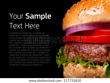 Burger isolated on black background. Fast food meal. 