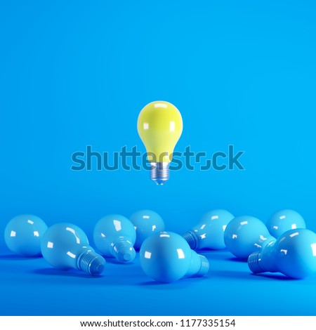 Yellow Lightbulb floating among blue lightbulb on background. minimal idea concept. Royalty-Free Stock Photo #1177335154