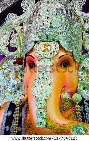 Close up view of an idol of Lord Ganesha, Tulshibaug Mandal, Pune, Maharashtra, India.