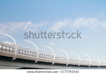 Modern high-speed automobile highway against the sky above a city, a technological design for the future. Negative space, minimalism style.