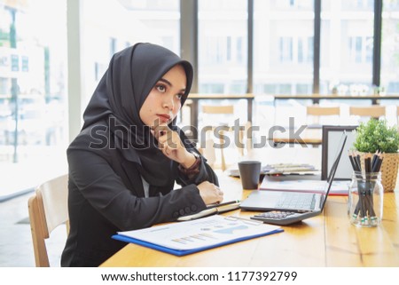 Portrait cute muslim woman sitting and use laptop computer.