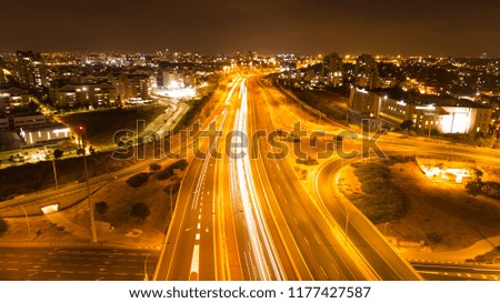 A beautiful long exposure aerial picture of a highway in the late night.