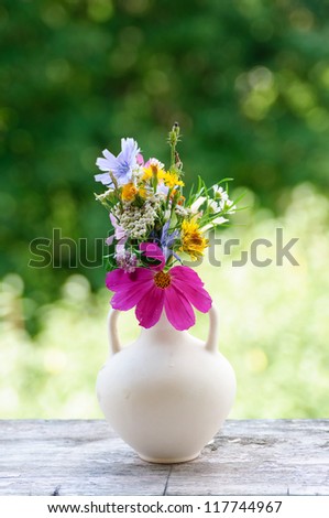 An image of flowers in a white vase