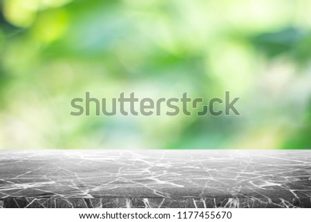 Gray marble stone counter top or table on backdrop blurred nature background / for display or montage your products / empty grey marble background concept.