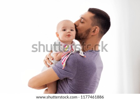 family, parenthood and people concept - happy father kissing little baby daughter