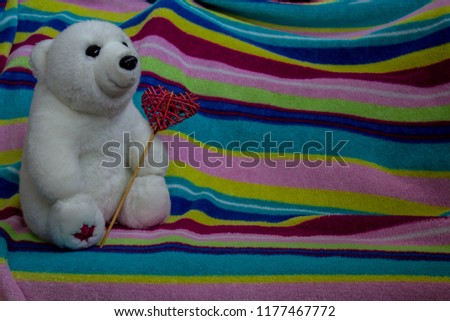 a beautiful white bear with heart in the paw
