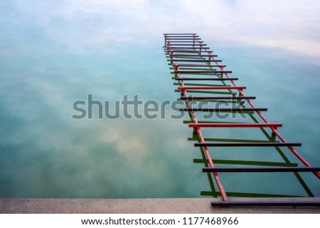 Photo of unfinished little bridge on the lake, abstract bridge to sky with clouds
