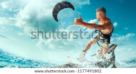 Kitesurfing. Man rides on kite on waves Royalty-Free Stock Photo #1177491802