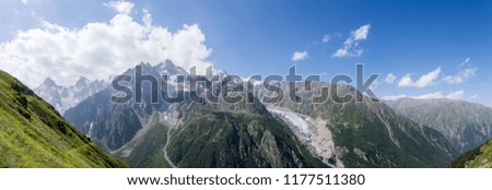 Image of mountain slopes with vegetation, cloudy sky
