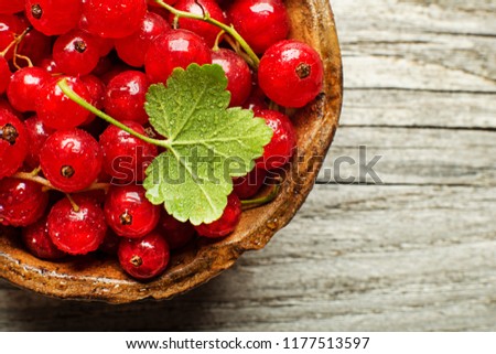 Fresh redcurrant berries on wooden background close up Royalty-Free Stock Photo #1177513597