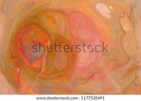 Fluid art. Abstract multicolored background. Orange spots of colors. Blurred pattern. Holographic texture on liquid