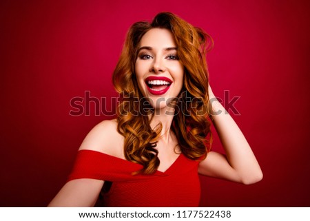 Cheerful, careless, carefree concept. Gorgeous, good-looking, alluring, magnificent make selfie on front camera of smartphone isolated on deep red background