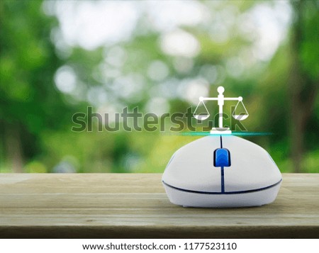 Law flat icon with wireless computer mouse on wooden table over blur green tree in park, Business legal service online concept