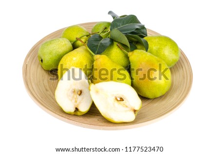 Ripe sweet pears on wooden platter. Studio Photo