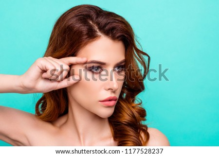 Botox, collagen, vitamins, minerals concept. Profile side view photo of woman holding fingers near eyes, looking at camera isolated on shine teal background with copy space for text