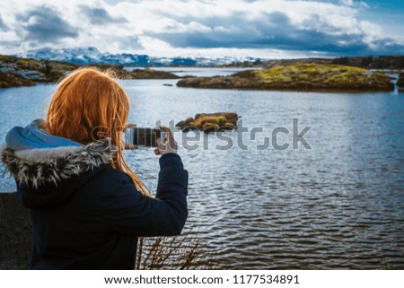 Girl Takes Photo of Lake Thingvellir in Iceland in Winter