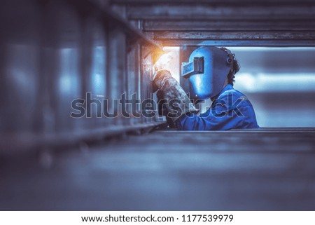 Industrial Worker labourer at the factory welding steel structure Royalty-Free Stock Photo #1177539979