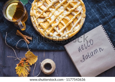 Autumn concept. Pie with Peaches Autumn Foliage Tea Honey Diary Hello Autumn on a wooden background Copy space Top view
