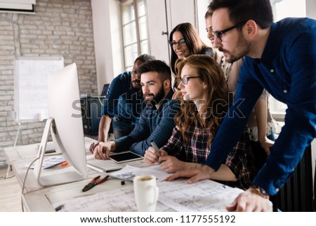 Picture of architects working together in office Royalty-Free Stock Photo #1177555192