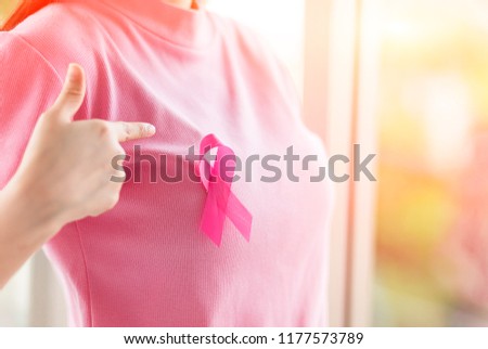 Close up Happy woman with a pink ribbon  for  Prevention Breast cancer or  Breast Cancer Awareness Concept. Royalty-Free Stock Photo #1177573789