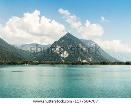 View of a nice piramidal mountain in a sunny summer day whit a turqouise lake near Interlaken in Switzerland