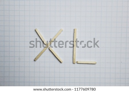 number 40 Roman numerals of matches on a white background. mathematics, knowledge, abacus. on a sheet in a cage
