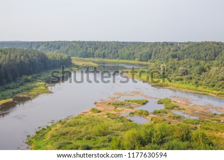 City Kraslava, Latvia. Early moorning with sunlight, river and trees. Nature photo with water. Travel photo 2018.